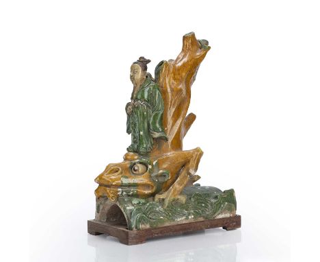 Large glazed roof tileChinese, Ming dynastydepicting a man standing on the head of a dragon leaning back on a tree trunk, 30c