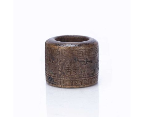 Carved wooden archers ringChinesecarved with taotie decoration, 3.5cm diameter x 2.75cm high in a pewter case with seal to th