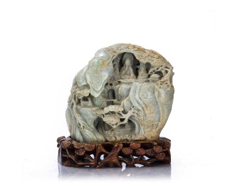 Carved jade boulderChinese, late 19th/ early 20th Centurywith scholars on a bridge in a cavernous landscape to one side, and 