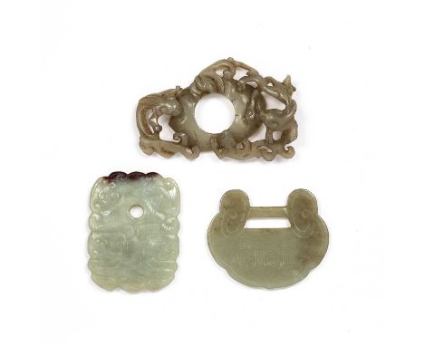 Grey green jade pendantChinese, 19th Centurycarved as a Bi style ring with four C scroll motifs on the reverse and encircled 
