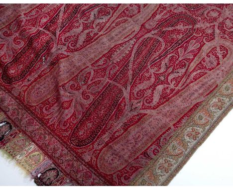 Large Kashmiri shawl Indianof red ground colour, decorated with scrolling leaves, the centre with a green circular panel 270c