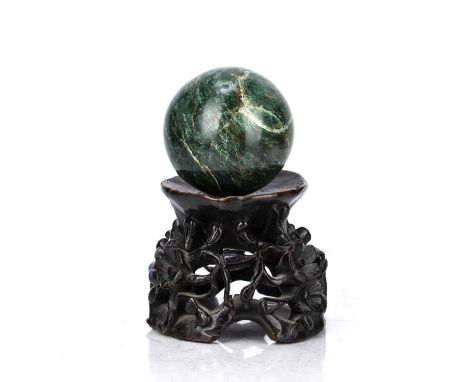 Nephrite jade sphere with a wooden baseChinese, 18th/19th Centurythe stand carved with flowers on vines, diameter of the sphe