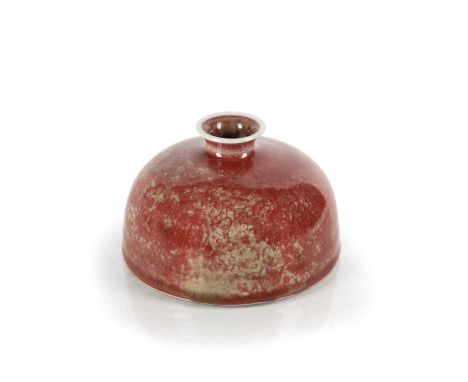 Peach bloom water pot of beehive formChinese, Kangxi (1662-1722)with short neck and lipped rim, the dark red glaze with scatt