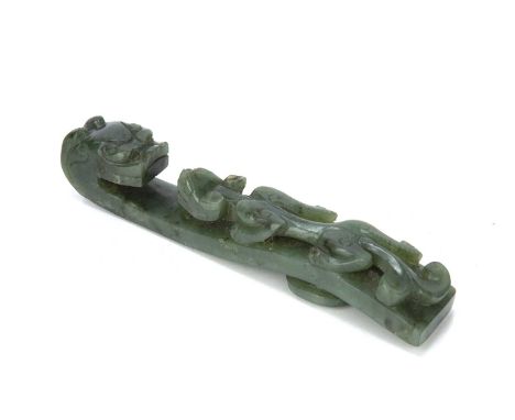 Spinach jade belt buckleChinese, 19th Centurycarved in the form of a dragon, 14 cm longProvenance: It has been in the family 
