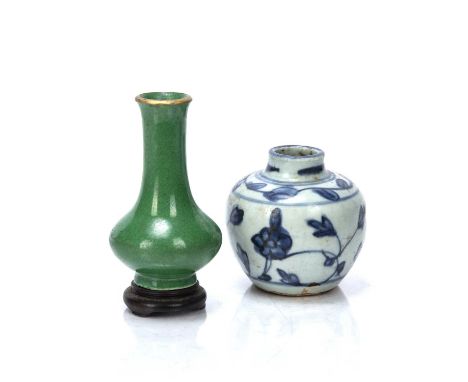 Green glazed small vaseChinese, 19th Centuryhaving a gilt rim, and with old collection label and a hardwood stand, 10cm high 