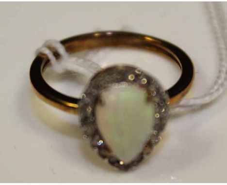 OPAL AND DIAMOND CLUSTER RING
the pear shaped opal surrounded by diamonds, in nine carat gold