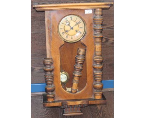 EARLY 20TH CENTURY WALL CLOCK
with two column supports, with brass enamel pendulum, 57.5cm long