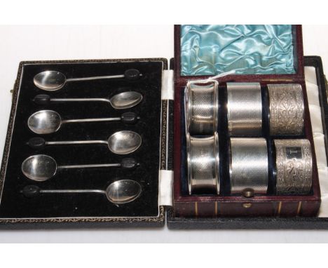 Case set of six silver coffee bean handle spoons, two pair of engine-turned silver napkin rings and EP pair, with case.