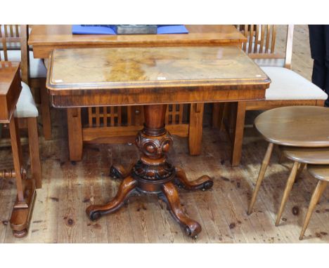 Victorian walnut fold top card table on turned carved pedestal to four scrolled legs, 75cm by 93cm by 46cm (closed).