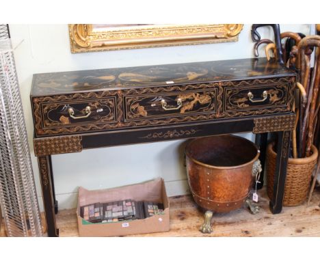 Oriental black lacquered and landscape decorated three drawer console table on stand, 79cm by 124cm by 33cm.