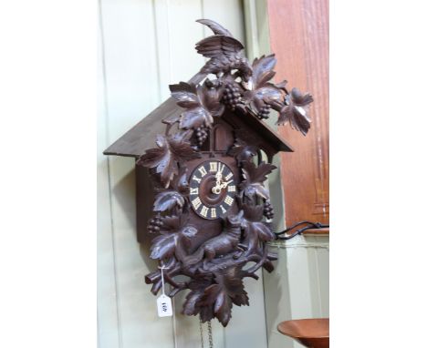 Black Forest carved cuckoo clock and weights.