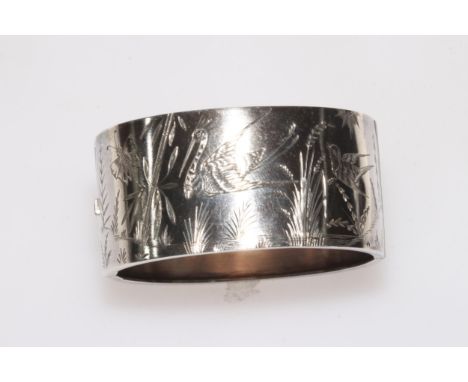 Silver hinged bangle with engraved decoration of birds, butterfly and water plants, 31mm wide.