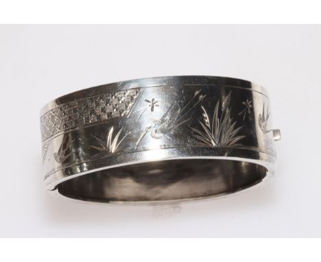 Silver hinged bangle with engraved decoration, 22mm wide.