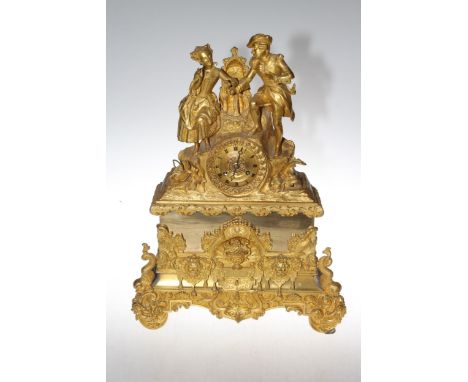19th Century decorative ormolu mantel clock, the circular dial with gallant and maiden figures, 50cm high.