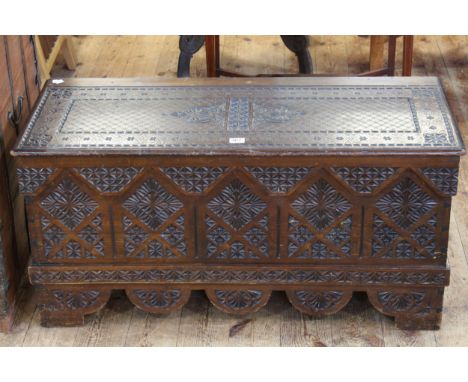 Carved arched panel front box/trunk, 46cm by 95cm by 41cm.