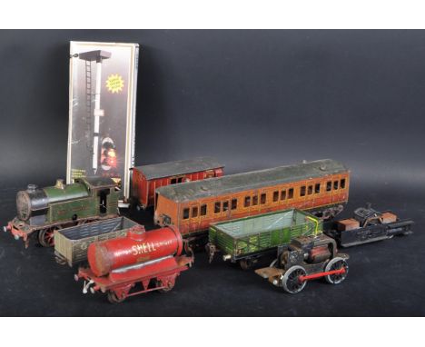 A collection of vintage Hornby O gauge tinplate clockwork model railway trainset locomotive and rolling stock wagons. The loc