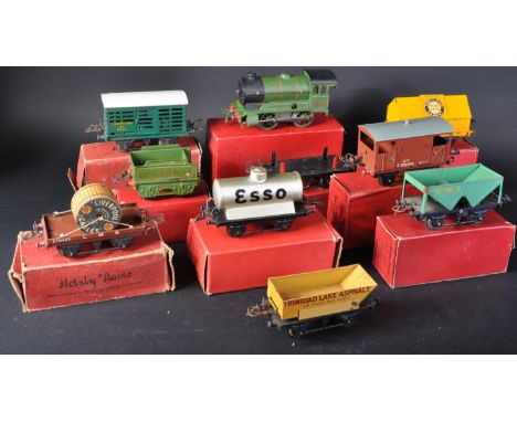 A collection of vintage Hornby O gauge tinplate clockwork model railway trainset coaches / carriages and locomotive. Examples