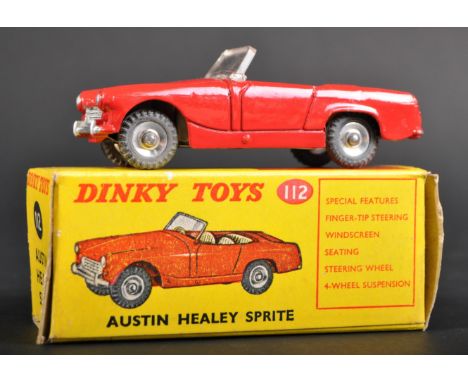 An original vintage Dinky Toys boxed diecast model No. 112 Austin Healey Sprite. The model with red bodywork, cream interiors