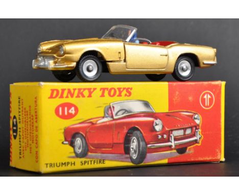 An original vintage Dinky Toys boxed diecast model No. 114 Triumph Spitfire. Gold bodywork with opening bonnet, detailed engi