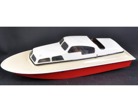 A vintage RC Radio Control model boat / pond yacht of fibreglass construction. The hull containing an Enya 40 engine, fuel ta