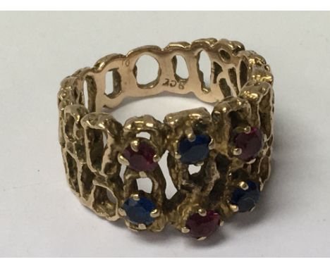 A ring of pierced design, inset with gem stones. Ring size O