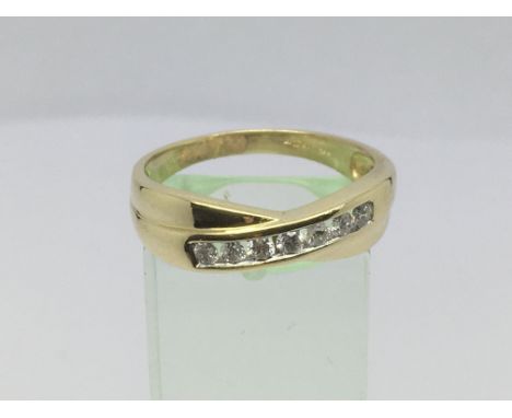 An 18ct gold seven stone diamond crossover ring, approx.33ct, approx 4.7g and approx size U-V.