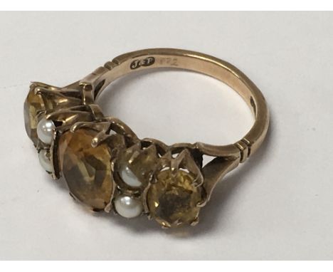 A 9ct gold ring inset with citrine and pearls. Ring size K