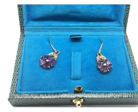 A pair of flower design drop earrings set with amethyst and diamonds, approx 2.4g.