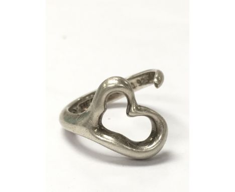 A Tiffany heart ring weighing approximately 4.7g and measuring approximately between ring size N and M. Complete with box and