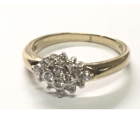A 9carat gold ring set with a pattern of sixteen brilliant cut diamonds.ring size P.