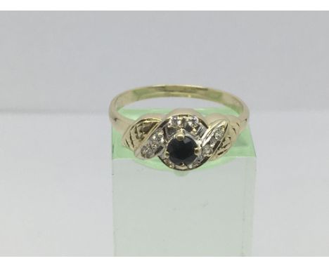 An 18ct gold ring set with a central sapphire and diamonds, approx .12ct, approx 2.9g and approx size P.