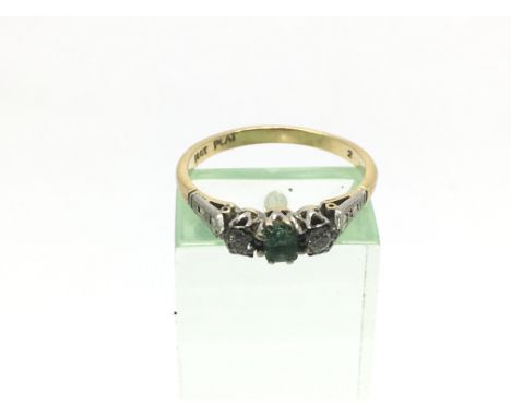 An 18ct gold and platinum ring set with a central emerald and diamonds, approx 2.7g and approx size P.