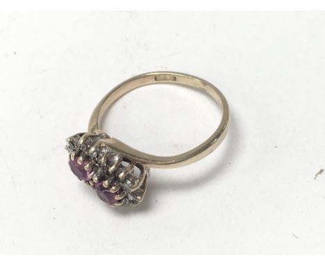 A 9ct gold ruby and diamond set ring. (J).