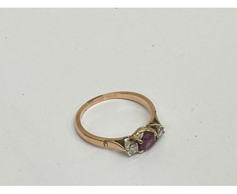 Two 9ct gold rings, a ruby and diamond three stone ring on a yellow metal mount, size N. A 9ct stone set eternity ring, some 