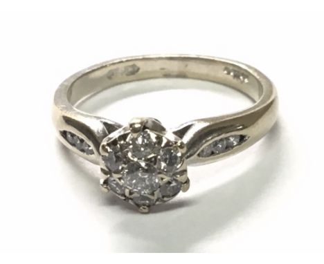 An 18carat gold ring set with a pattern of diamonds the shank set with further diamonds. Ring size J.