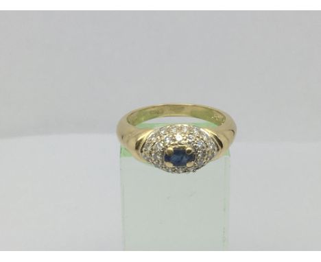 An 18ct gold ring set with a central sapphire surrounded by diamonds, approx 1/2 ct, approx 5.2g and approx size P.