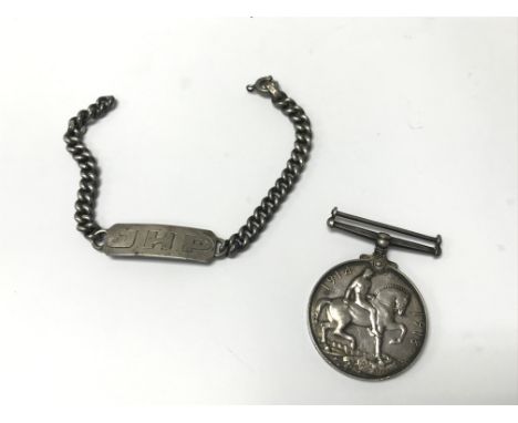 A World War 1 army service Corps medal and a silver ID badge.