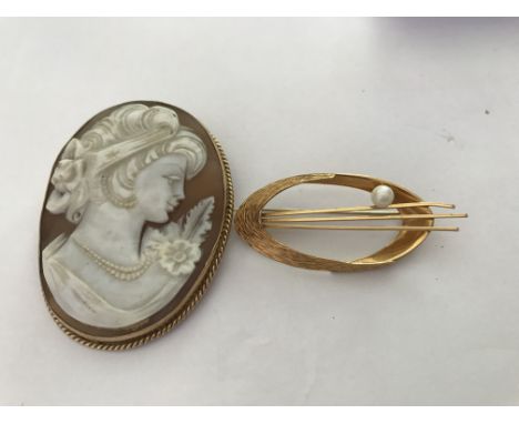 A 18 k gold contemporary brooch together with a cameo brooch with gold mount