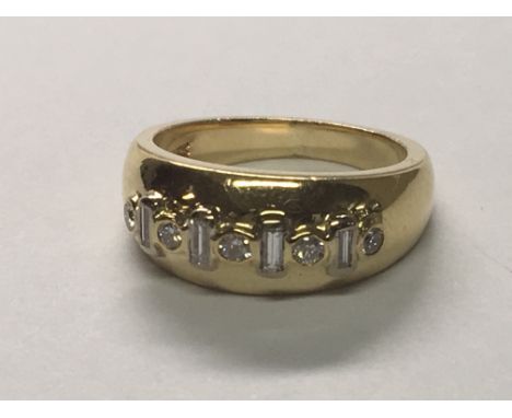 An unusual 18carat gold ring set with alternating brilliant cut and baguette diamonds. Total weight of the ring 9.6g ring siz