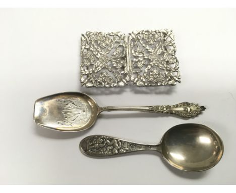 A white metal piercework buckle plus two silver caddy spoons (3).