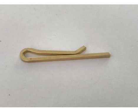 A 14 k gold tie clip .