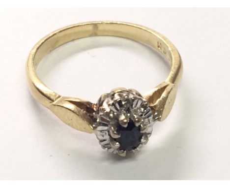 An 18carat gold ring set with a blue sapphire and chip stone diamonds ring size K.