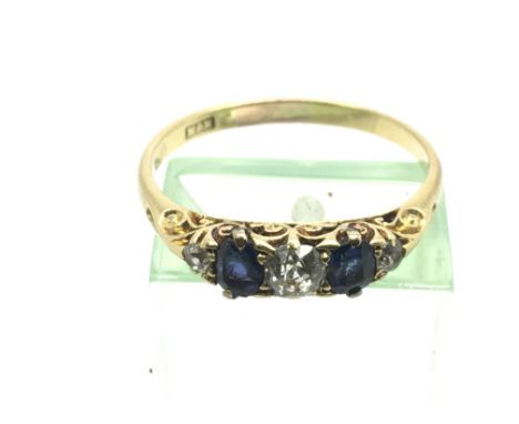 An unmarked gold ring set with diamonds and tanzanite, approx 2.9g and approx size S.