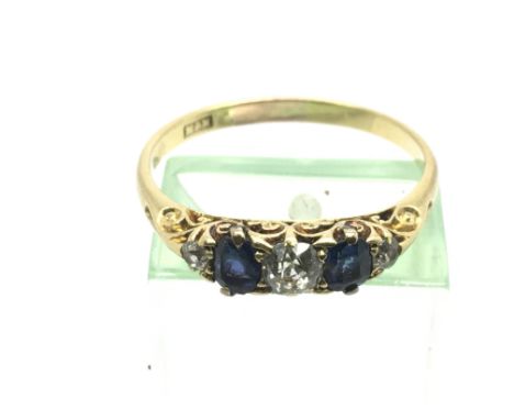 An unmarked gold ring set with diamonds and tanzanite, approx 2.9g and approx size S.