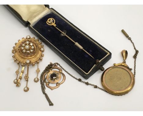 An unmarked Victorian pendant inset with seed pearls, together with two pendants and a tie pin