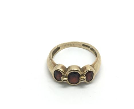 A 9ct gold three stone garnet ring, approx 3.6g and approx size P-Q.