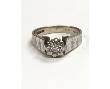An 18ct white gold ring set with a small diamond, ring size is approximately between K and L.