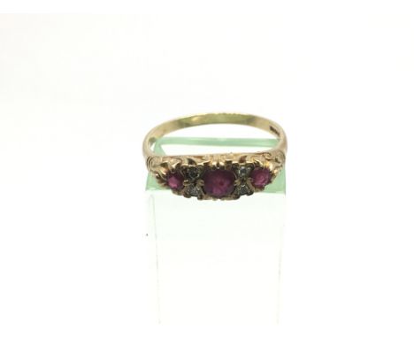 A 9ct gold ring set with diamonds and red stones, possibly rubies, approx 2.8g and approx size T-U.