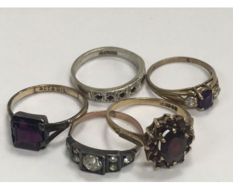 Four 9ct rings inset with various gem stones together with a 9 pct gold ring inset with an amethyst.