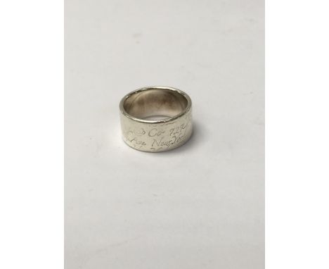 A Tiffany 10mm band ring weighing approximately 8.8g with bag and pouch. The ring size is approximately o.